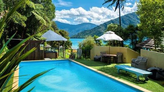 Heated outdoor thermal pool at Happymotion with alpine views